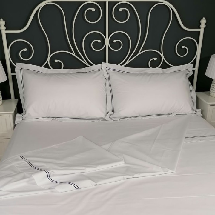 Flat sheet blue trim Egyptian Cotton 200 Thread Count Percale Porto laid out on bed